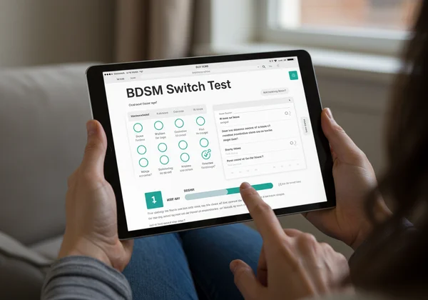 Person using a modern BDSM role test on a digital device.